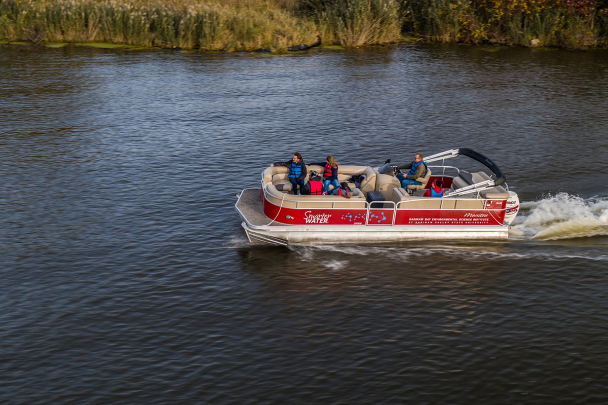 red pontoon boat on river